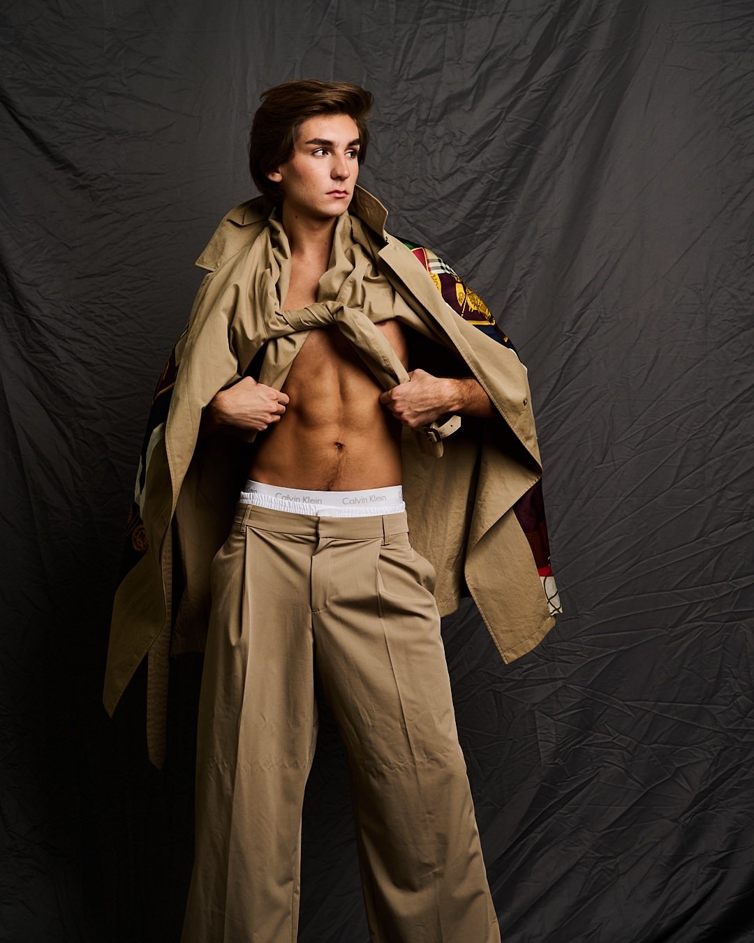 Austin in a camel trench coat