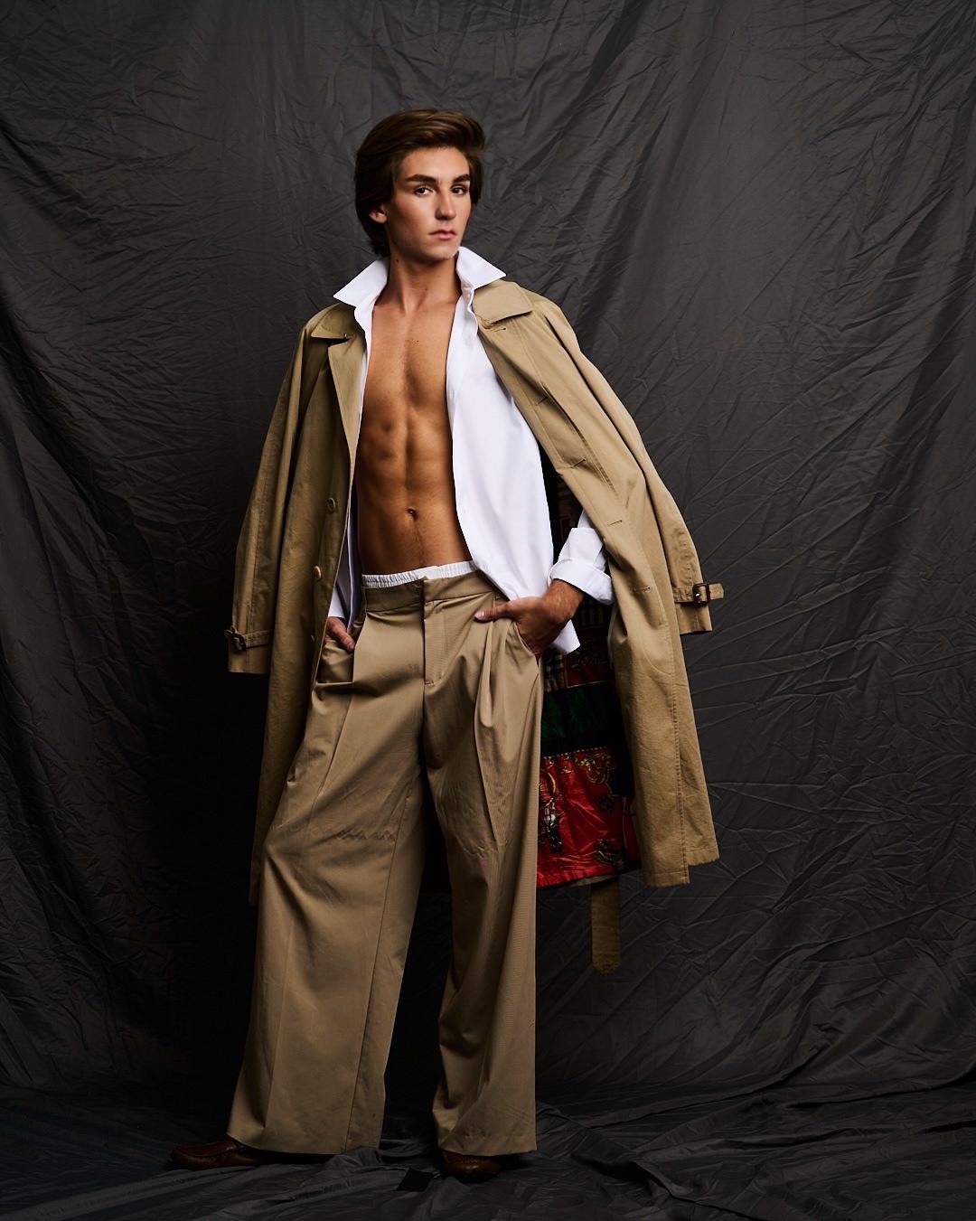 Austin in a camel trench coat