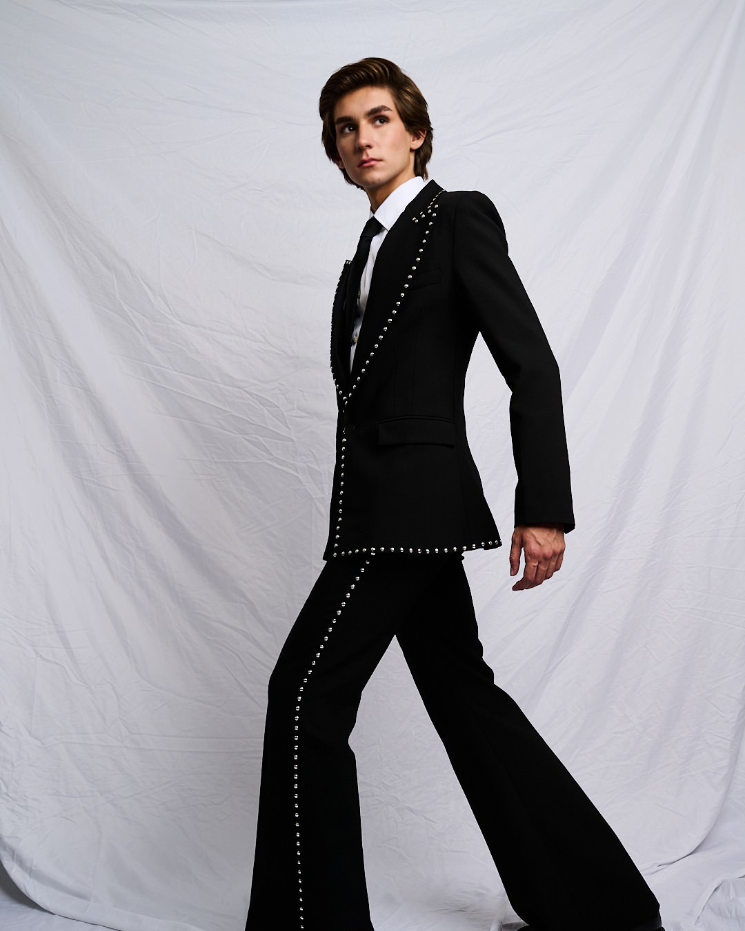 Austin in a studded black suit