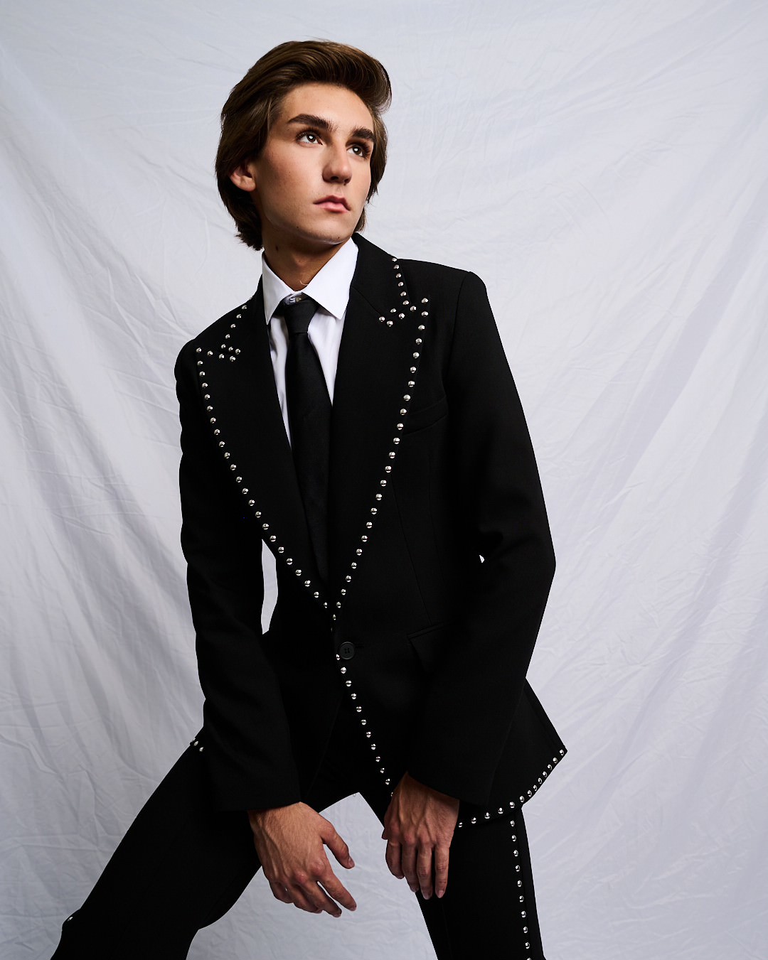 Austin in a studded black suit