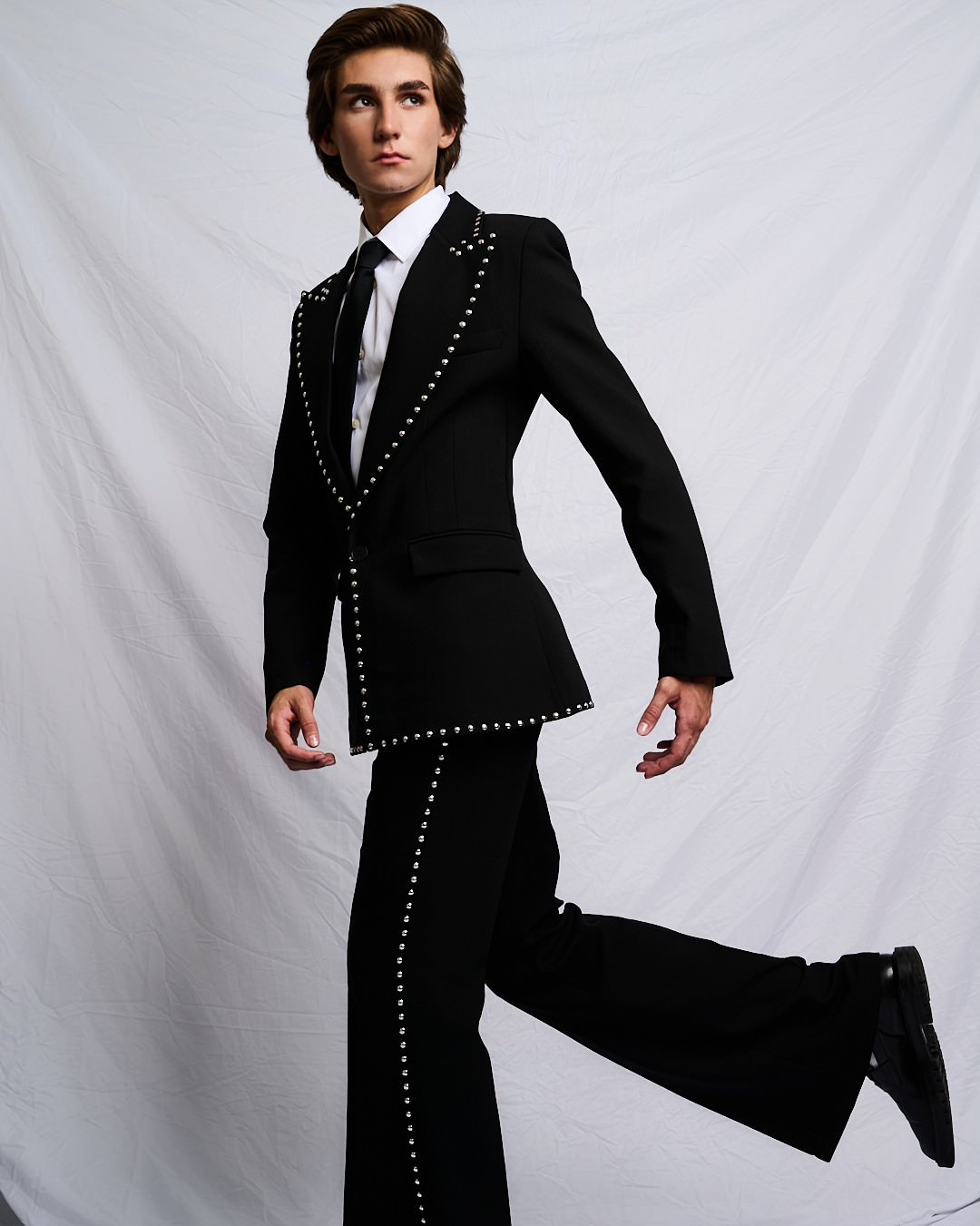 Austin in a studded black suit
