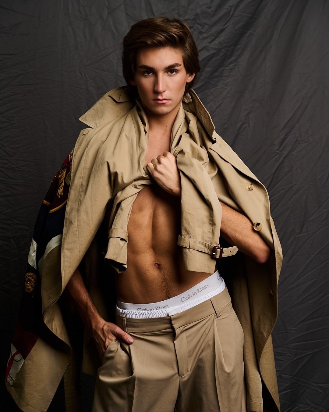 Austin in a camel trench coat