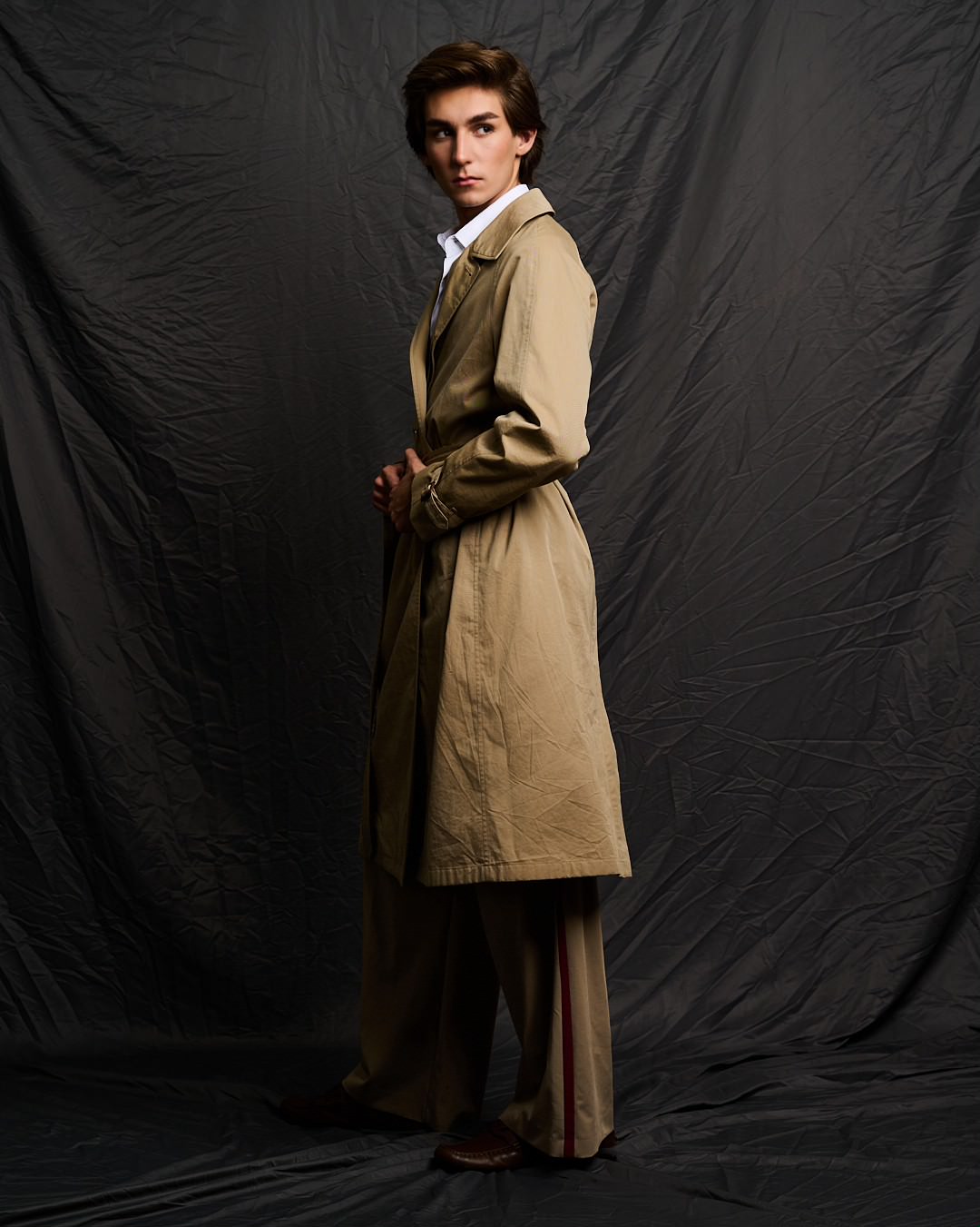 Austin in a camel trench coat