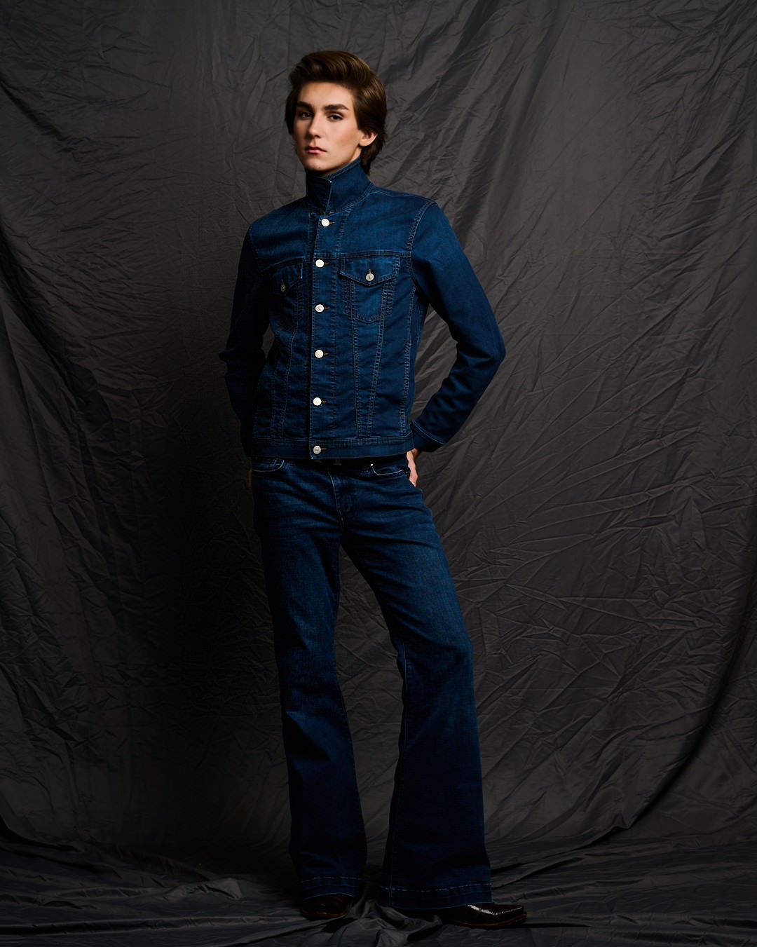 Austin in a denim jacket and flared jeans