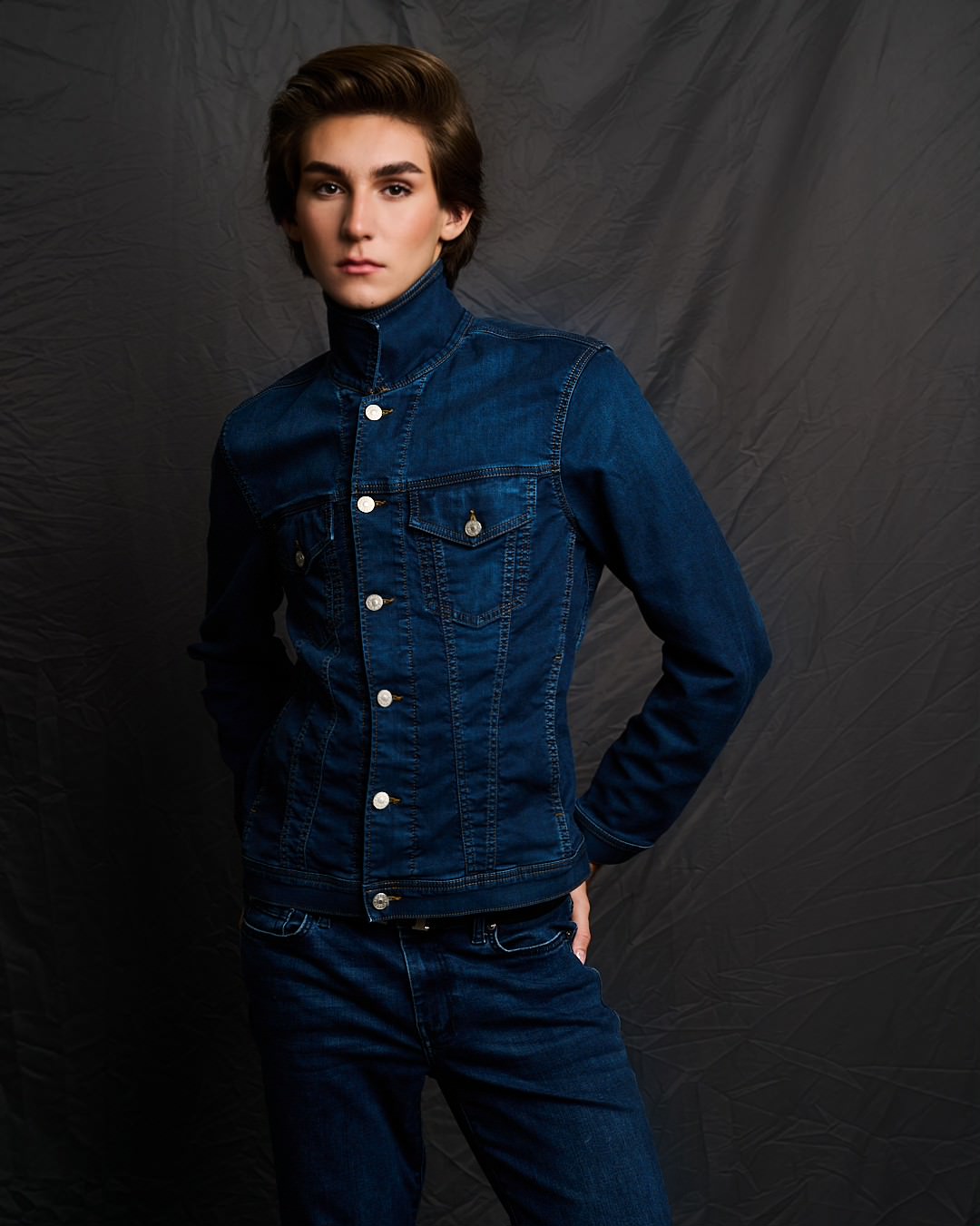 Austin in a denim jacket and flared jeans
