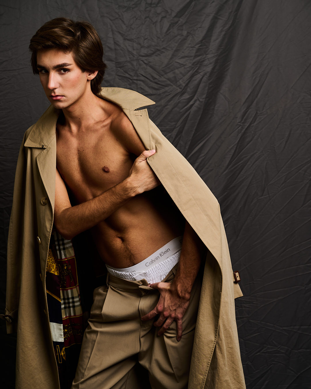 Austin in a camel trench coat