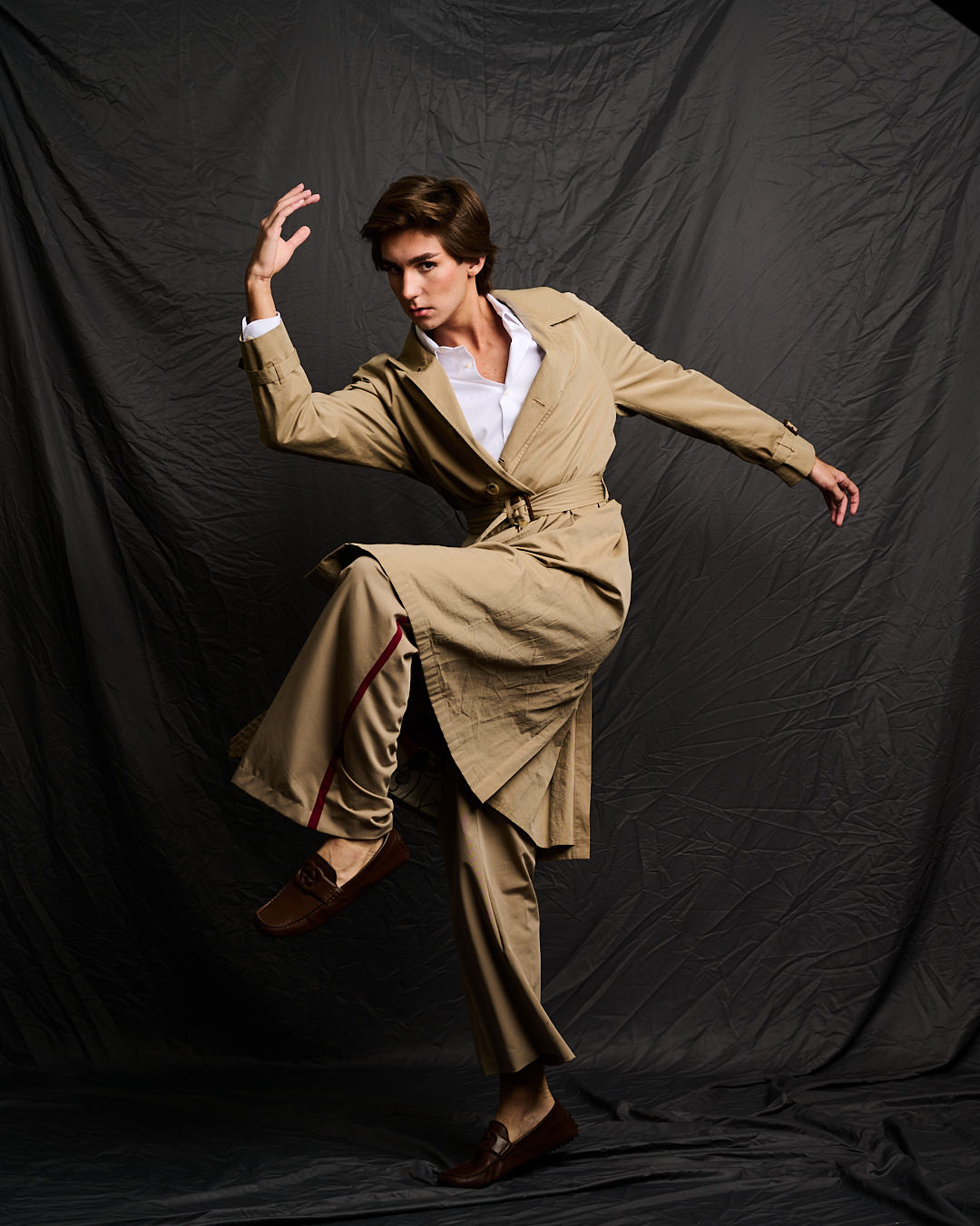 Austin in a camel trench coat