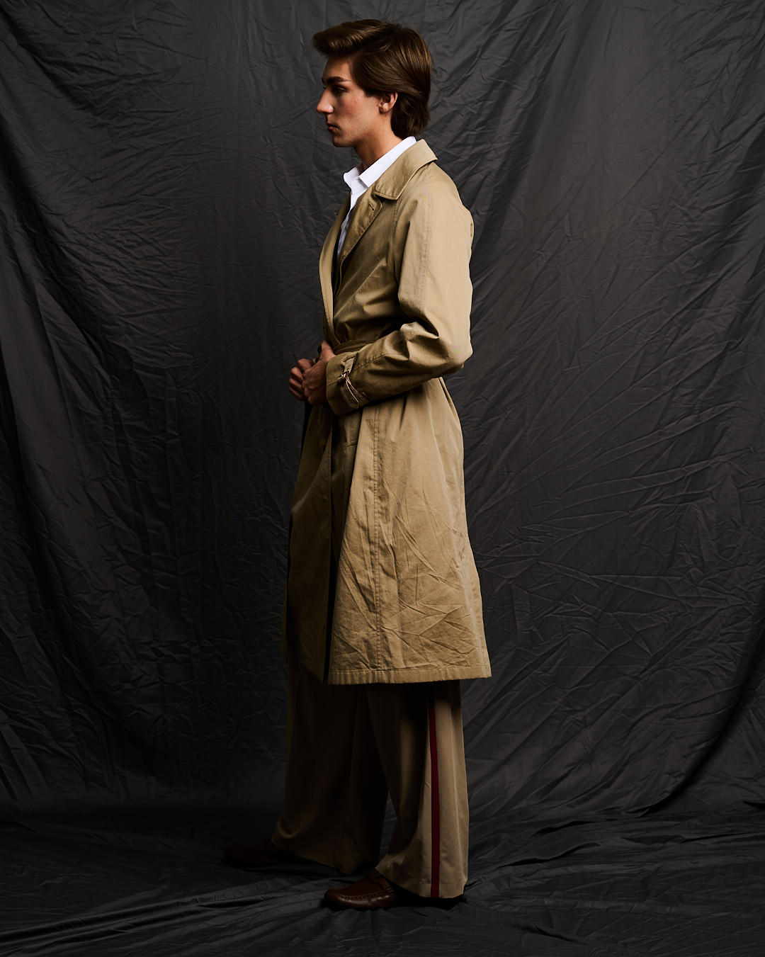 Austin in a camel trench coat
